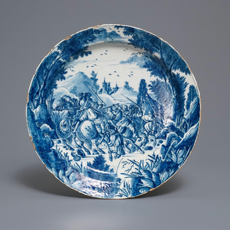 A very fine Dutch Delft blue and white dish with fighting horseriders, 18th C.